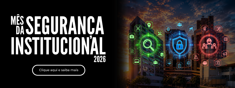 Banner do Mês da Segurança Institucional 2026. Do lado esquerdo, sobre fundo preto, está escrito em letras maiúsculas e destacadas em branco Mês da Segurança Institucional 2026 e, abaixo, o botão Clique aqui e saiba mais. Do lado direito, há uma imagem de prédios urbanos ao entardecer com ícones luminosos nas cores verde, azul e vermelha representando monitoramento, proteção cibernética e segurança do trabalho.